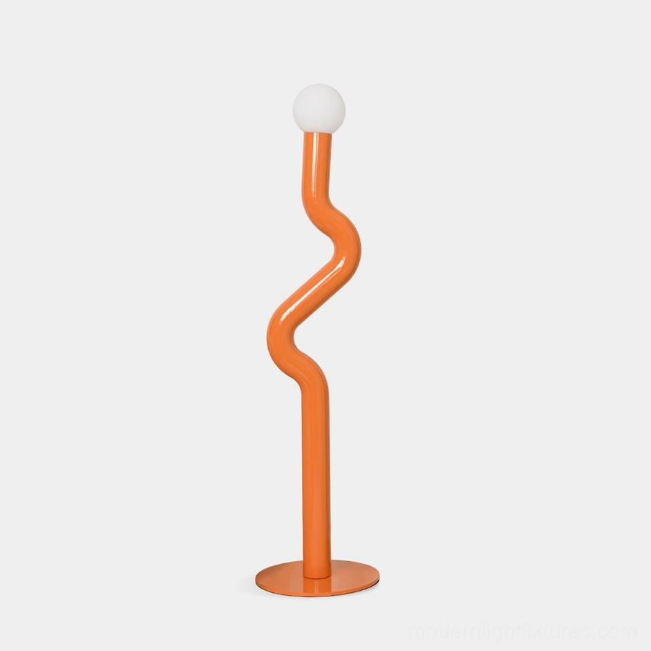 Twistie sculptural floor lamp with twisted metal pole in vibrant orange, featuring frosted glass globe diffuser on white studio background