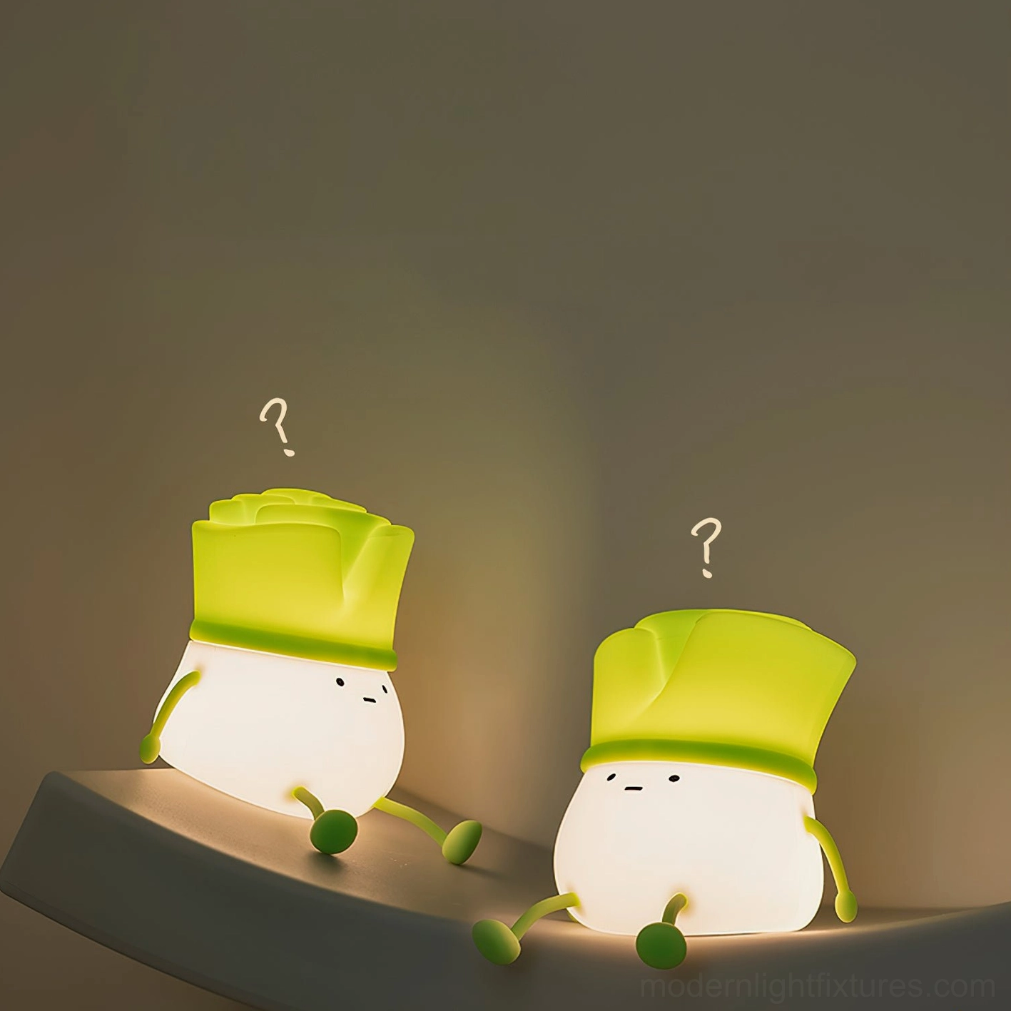 Two bok choy silicone night lights on bedside shelf creating ambient lighting