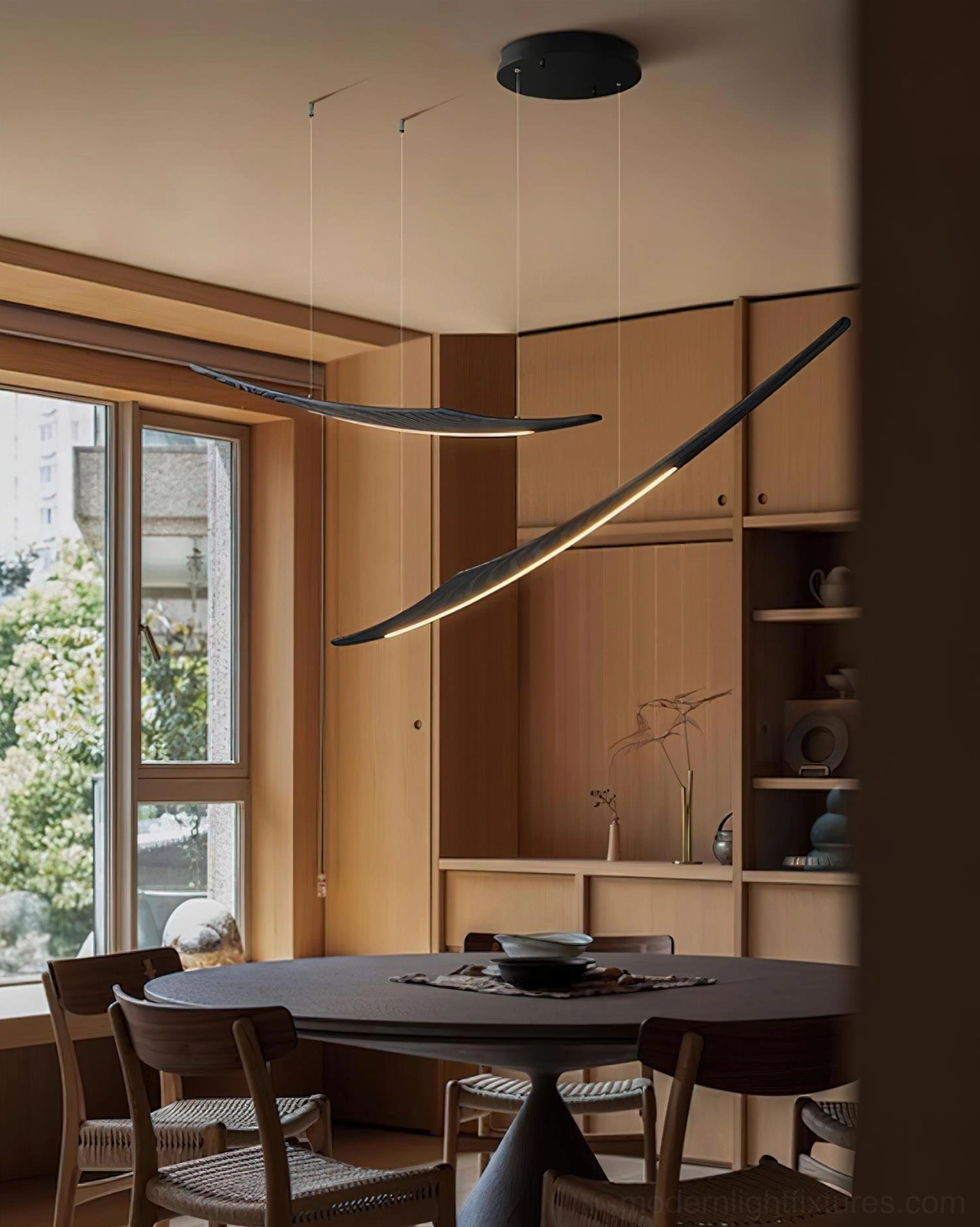 Two-head kinetic arc pendant chandelier configuration in contemporary interior setting