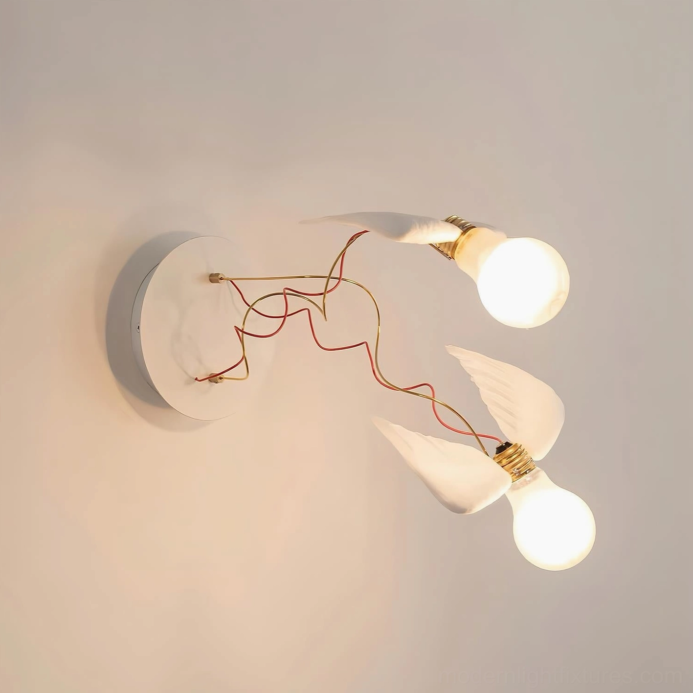 Two-head feathered wing wall sconce with white resin and brass accents, dual bulb configuration