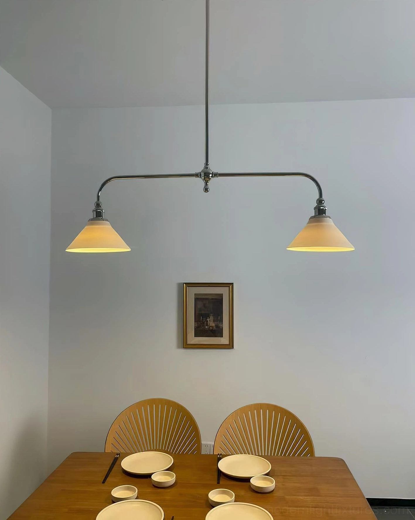 Two-head linear pendant chandelier with brass frame and matching ceramic shades demonstrating geometric design principles