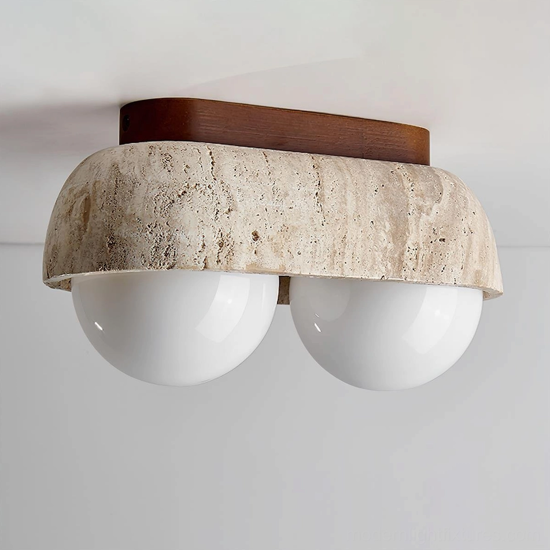 2-head travertine ceiling lamp with warm atmospheric lighting in neutral interior setting