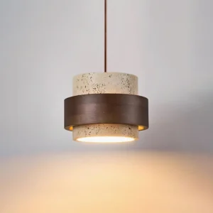 Two-head travertine pendant light fixture with warm downward glow, low angle view demonstrating stone diffused illumination effect