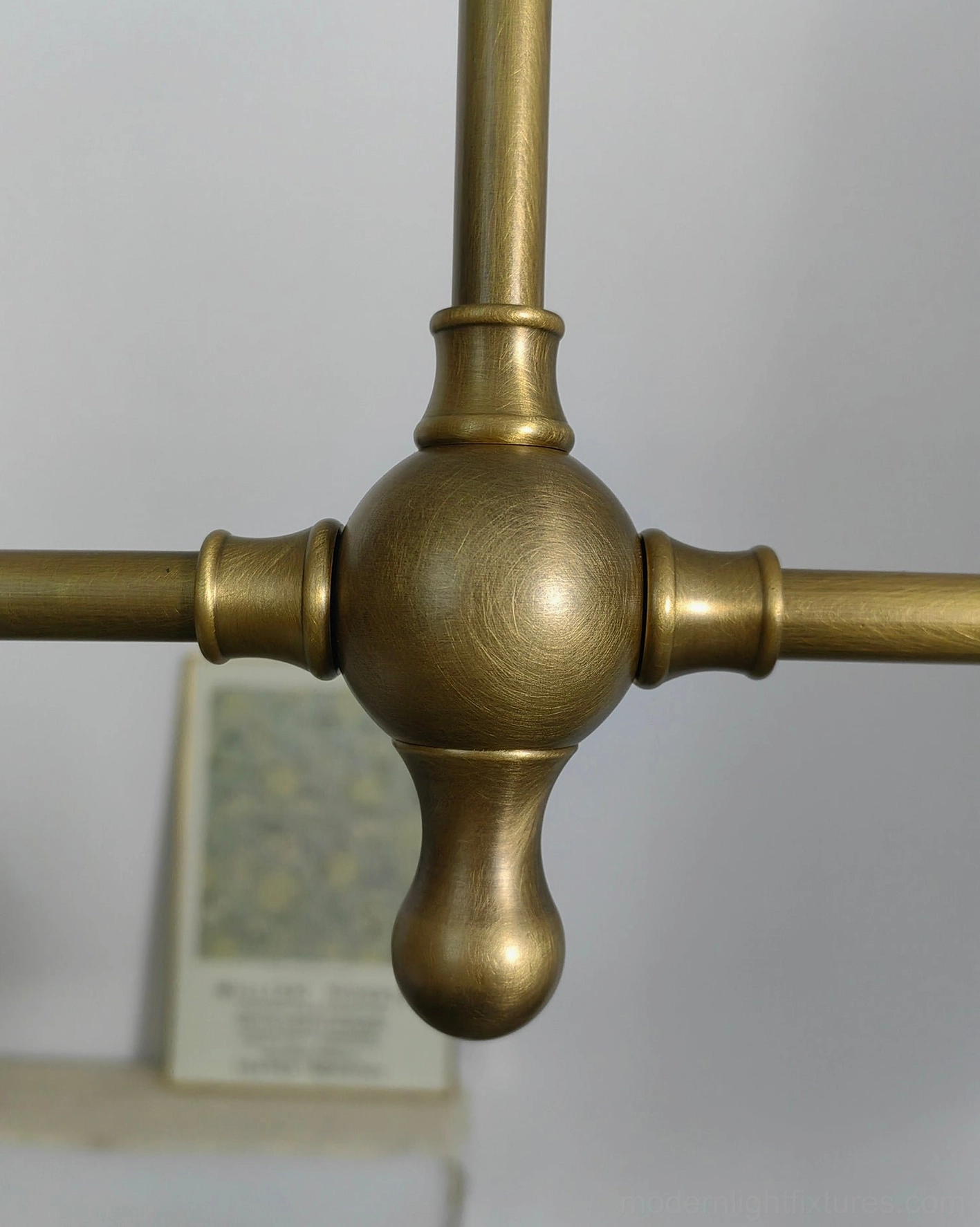 Two-light brass linear chandelier suspended in transitional interior space with neutral tones and classic design elements