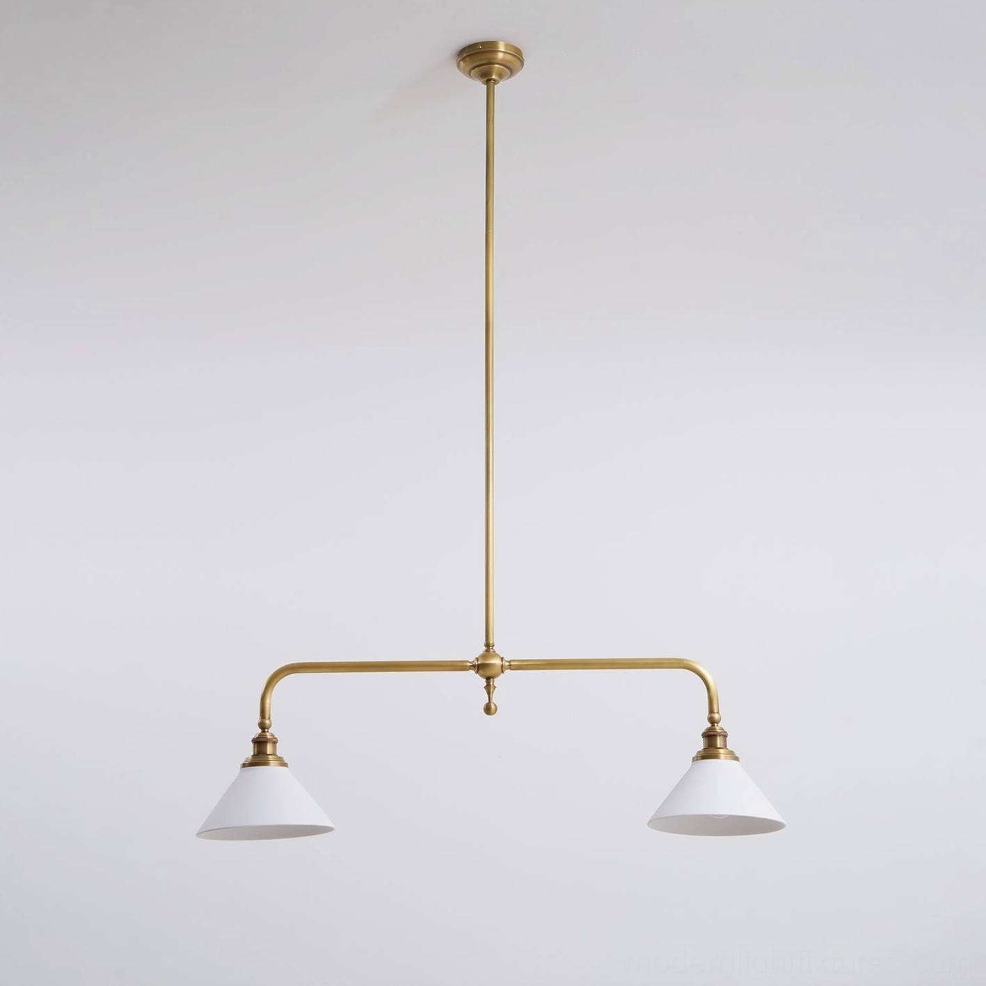 Two-light brass linear chandelier with white ceramic conical shades displaying elegant proportions and timeless design