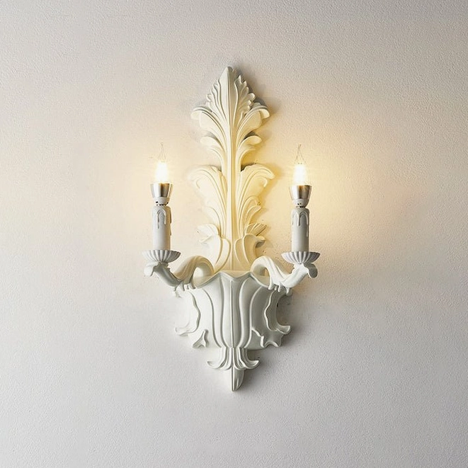 Two-light carved acanthus wall sconce in matte white with E14 candle bulbs and faux-drip sleeves