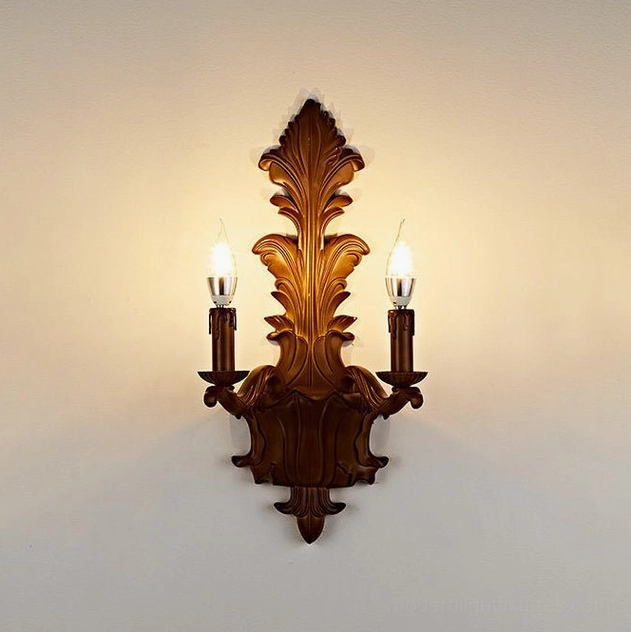 Two-light carved acanthus wall sconce in faux-wood finish showing candle-style flame-tip arms