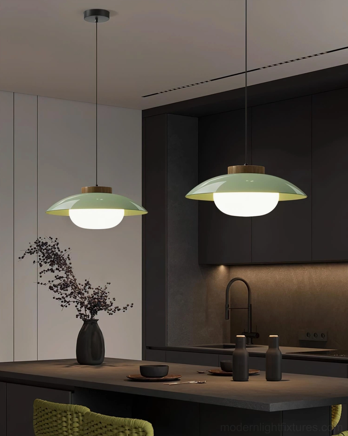 Two staggered sage green saucer pendant lamps above wooden dining table, modern Scandinavian lighting arrangement
