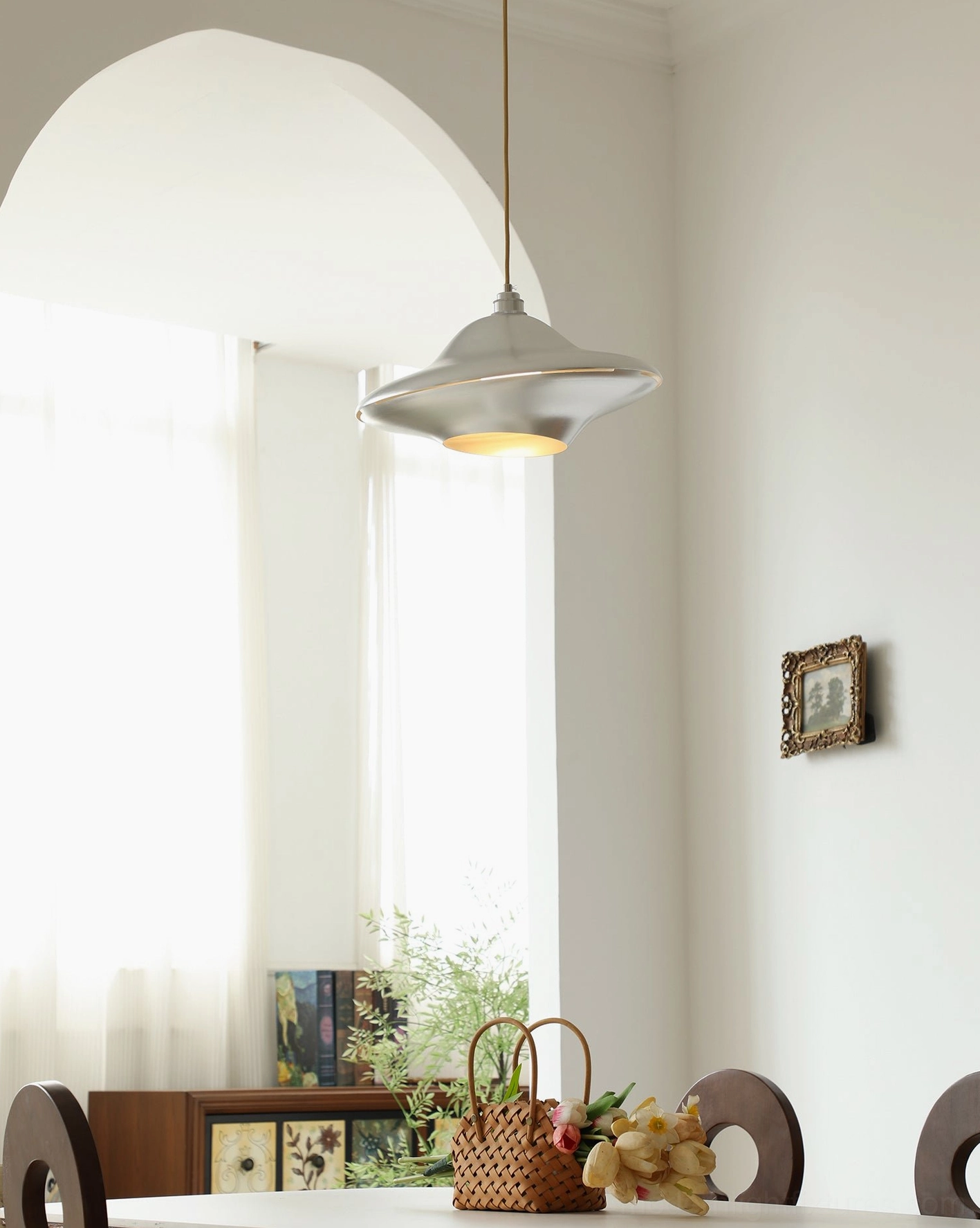 UFO ceiling pendant light installation - modern space-age fixture in dining area with architectural ambiance