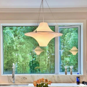 UFO pendant light in Nordic kitchen overhead view warm ambient lighting contemporary home