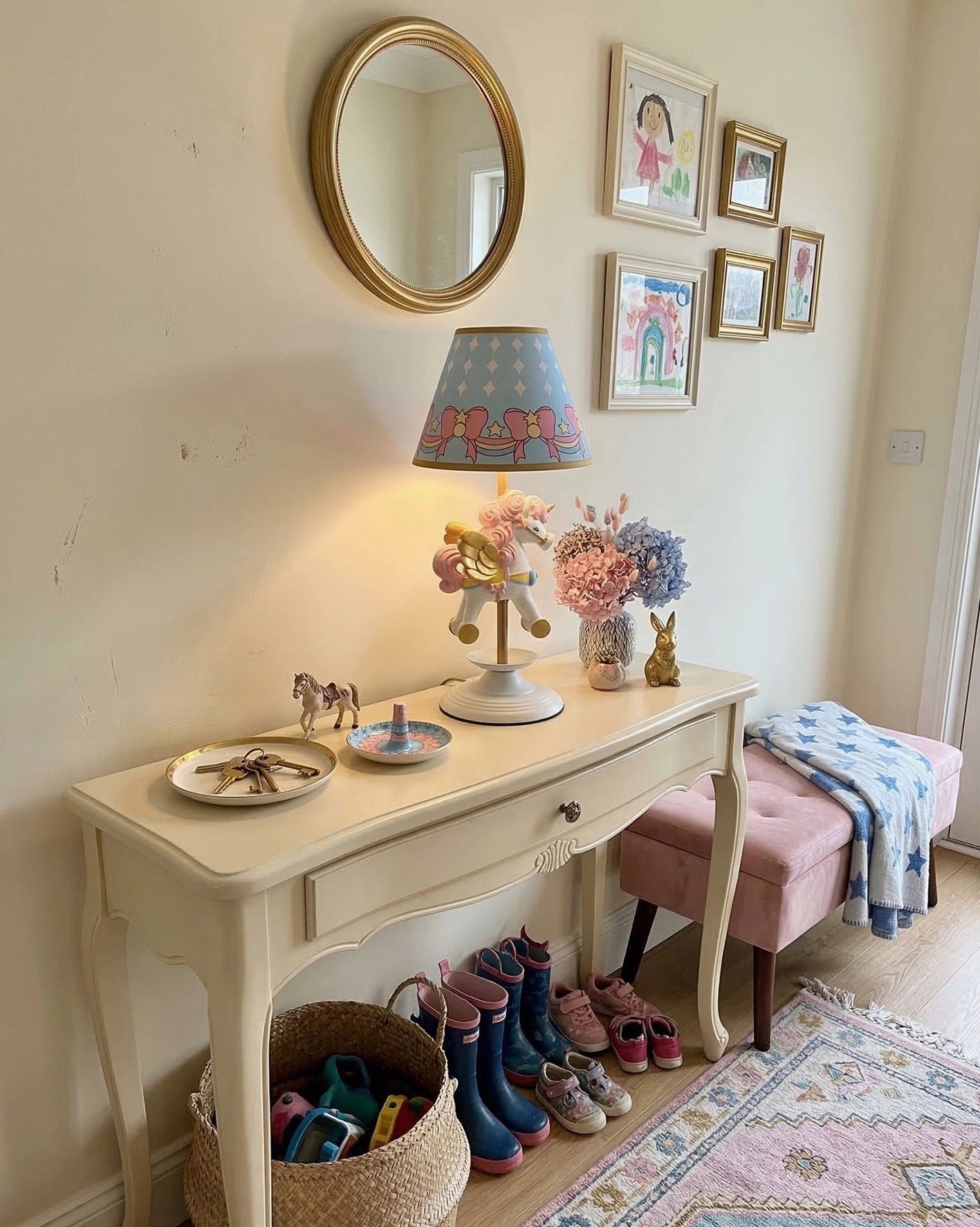 Lit unicorn carousel lamp creating soft ambient lighting in warm cream hallway with wall art and decorative accessories