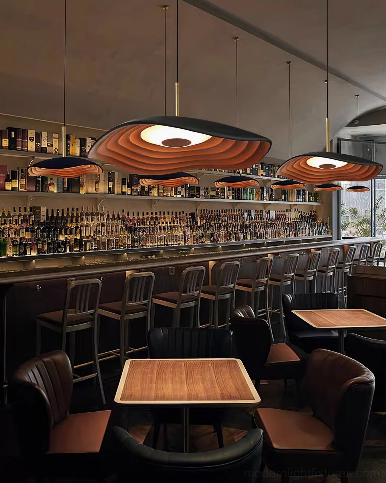 Valentina dark brown wavy disc pendant lights installed in commercial restaurant bar area with seating