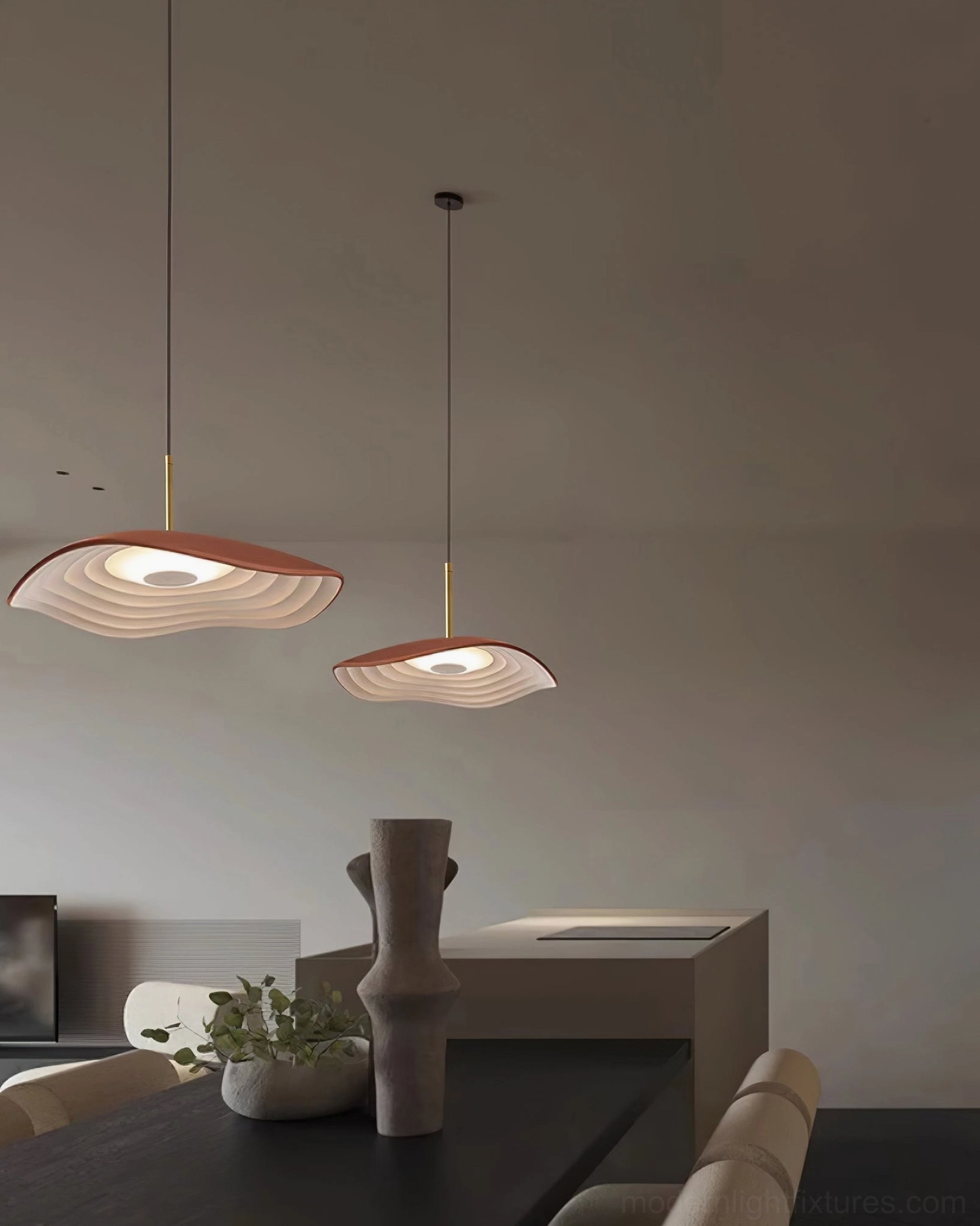 Valentina wavy disc pendant lights installed in modern dining space with minimalist interior and warm ambient lighting