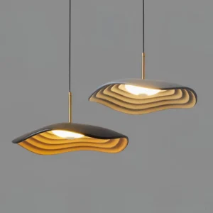 Two Valentina modern wavy pendant lights in contrasting colors with layered resin shades and brass suspension hardware