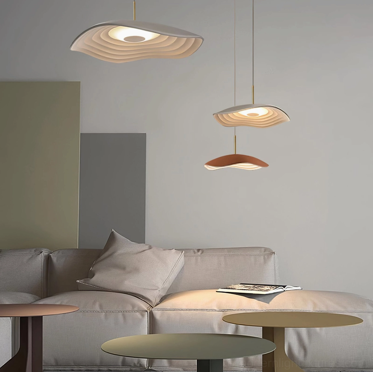 Three Valentina wavy pendant lights with mixed warm color shades installed in modern minimalist living room above sofa