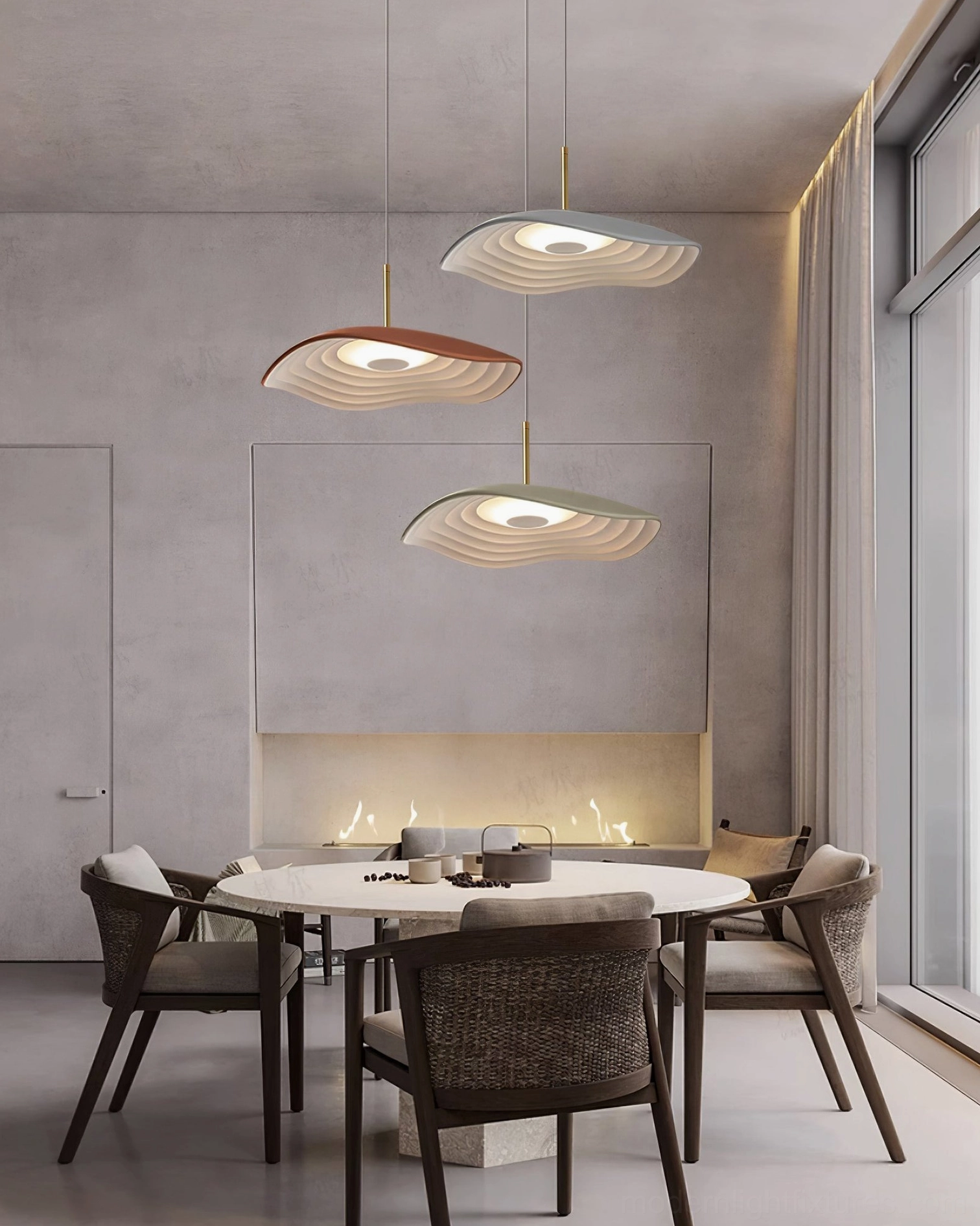 Three Valentina wavy pendant lights suspended in modern round dining area with neutral tones and warm ambient illumination