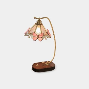 Valerie Butterfly vintage table lamp with brass curved arm and walnut wood base featuring decorative pink butterfly accents on fabric shade, front view on white background