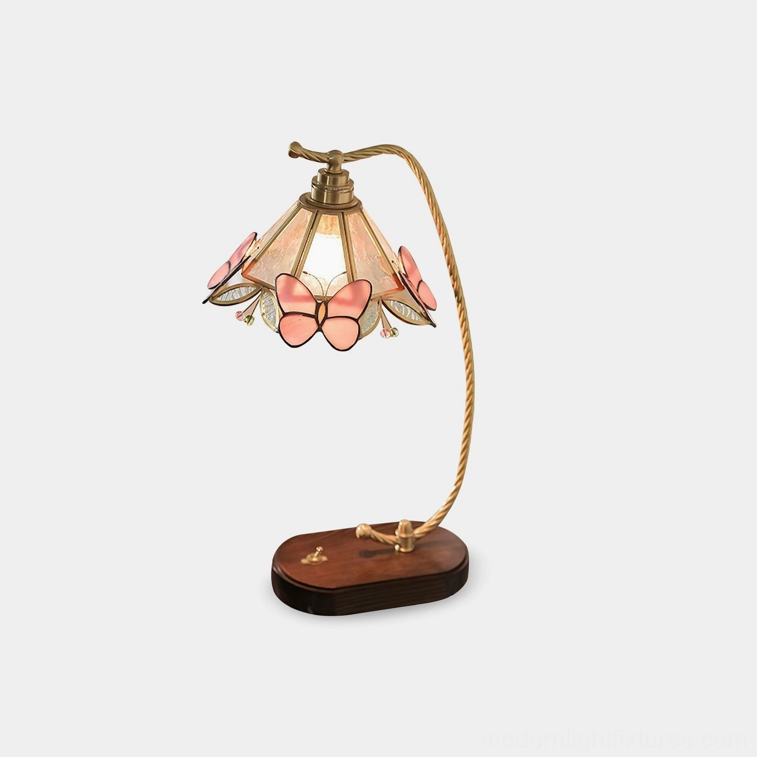 Valerie Butterfly vintage table lamp with brass curved arm and walnut wood base featuring decorative pink butterfly accents on fabric shade, front view on white background