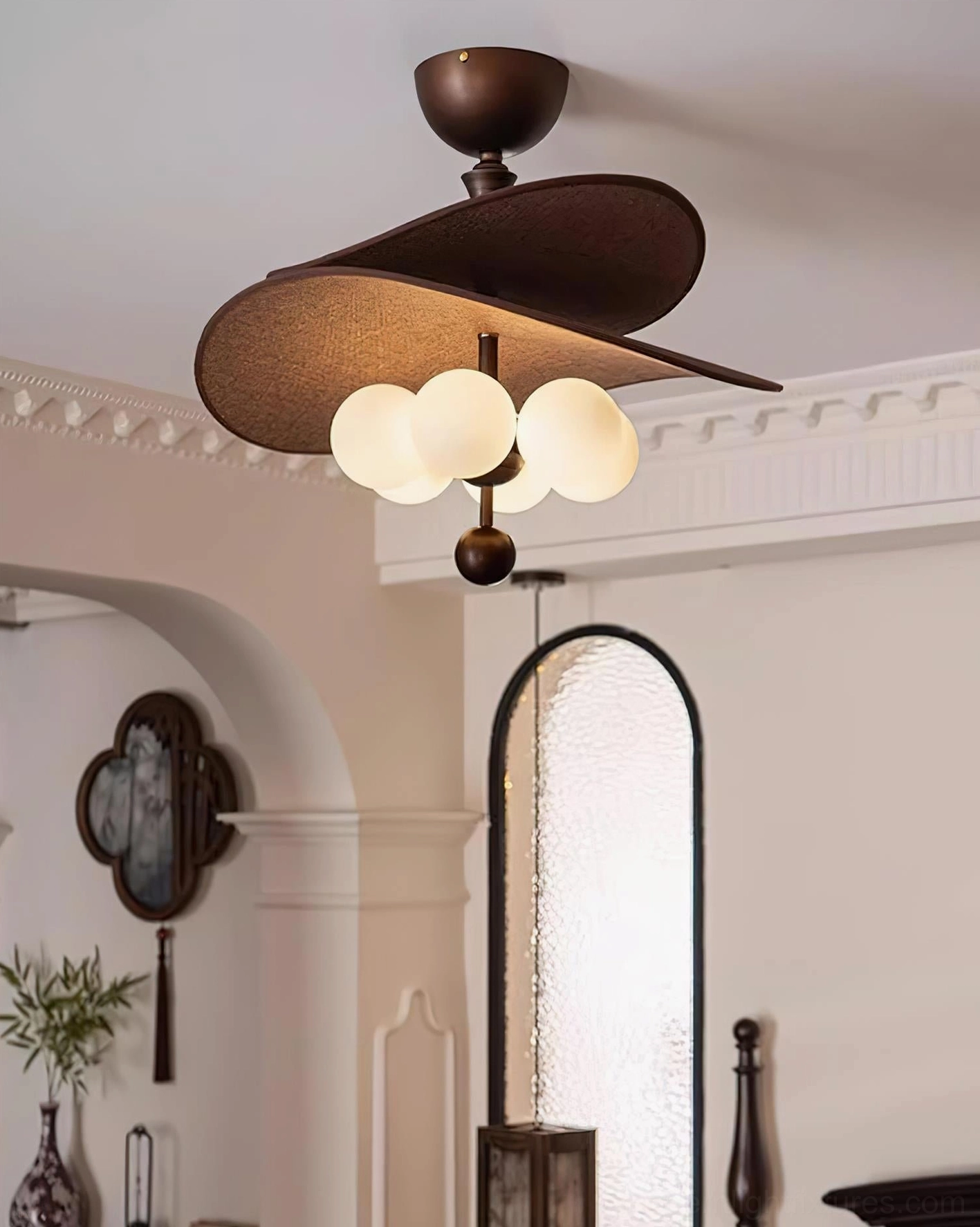 Valmorra ceiling lamp side detail view showing asymmetrical layered brown fabric shades, frosted globe bulbs, bronze metalwork, vintage bedroom setting