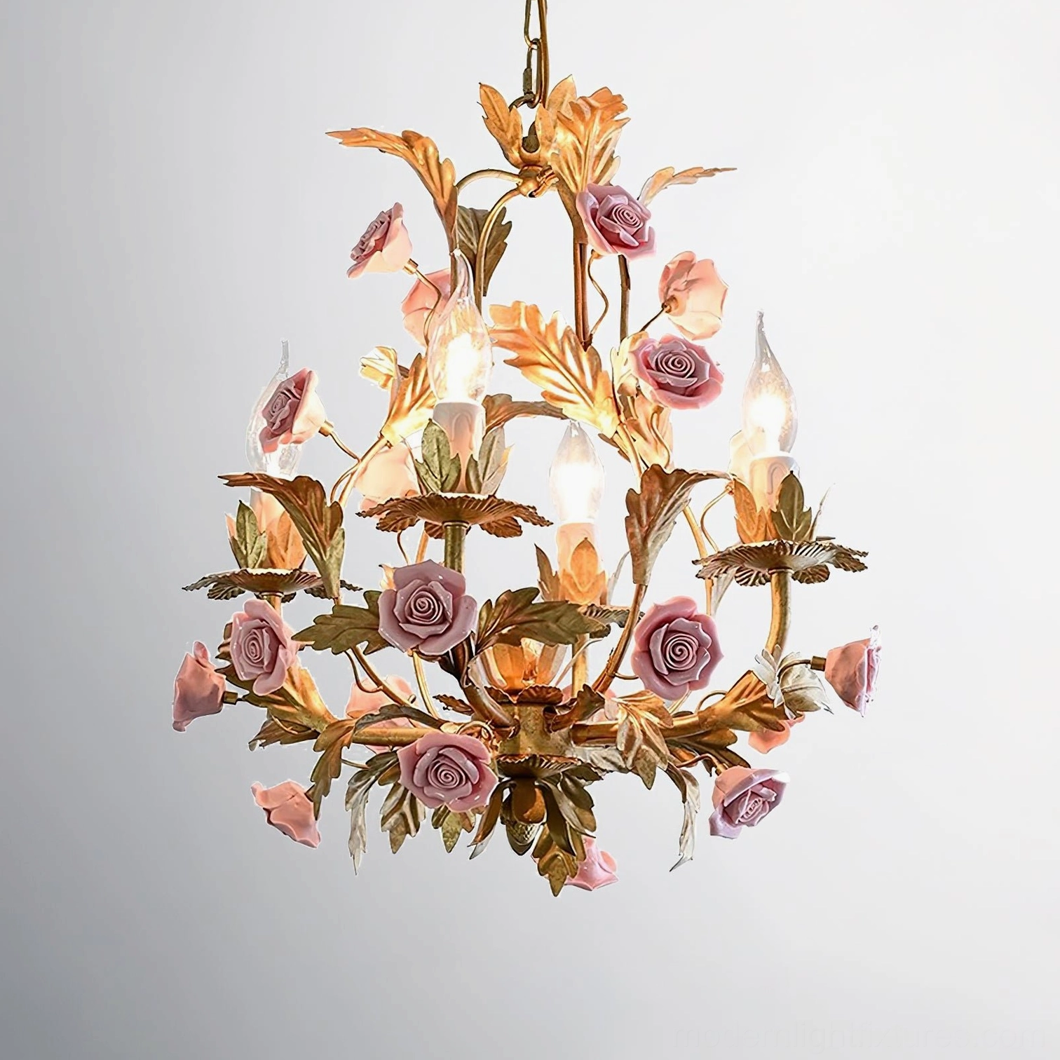 Valrosa floral chandelier providing warm ambient lighting with artistic pink rose and gold metal design