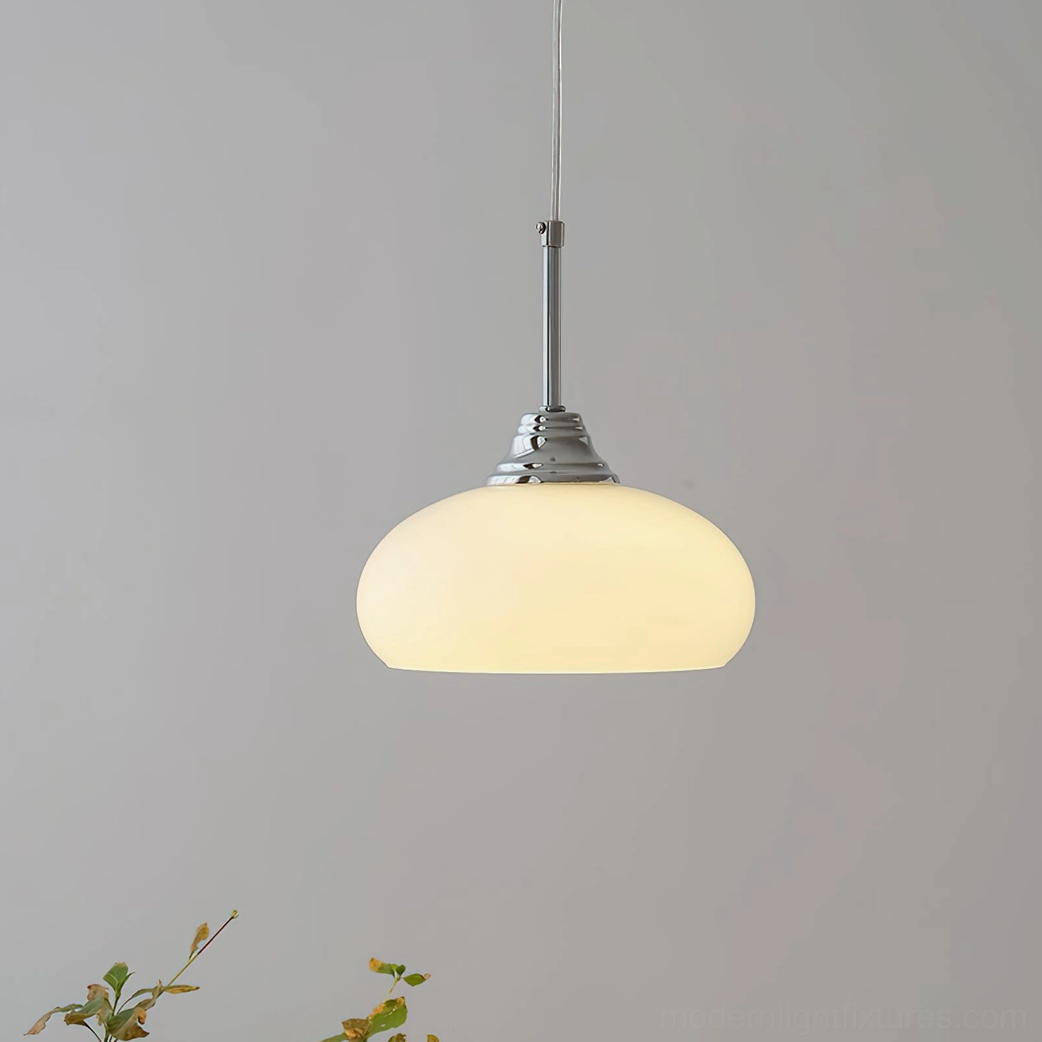 Glowing vanilla pendant light with illuminated cream glass shade and polished chrome fixtures