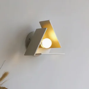 Vanta modern wall sconce three-quarter side angle showing dimensional panels with warm interior lighting and dried wheat styling