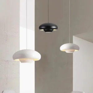 Vario modern pendant lights in black and white, suspended in contemporary wabi-sabi interior space with warm ambient lighting