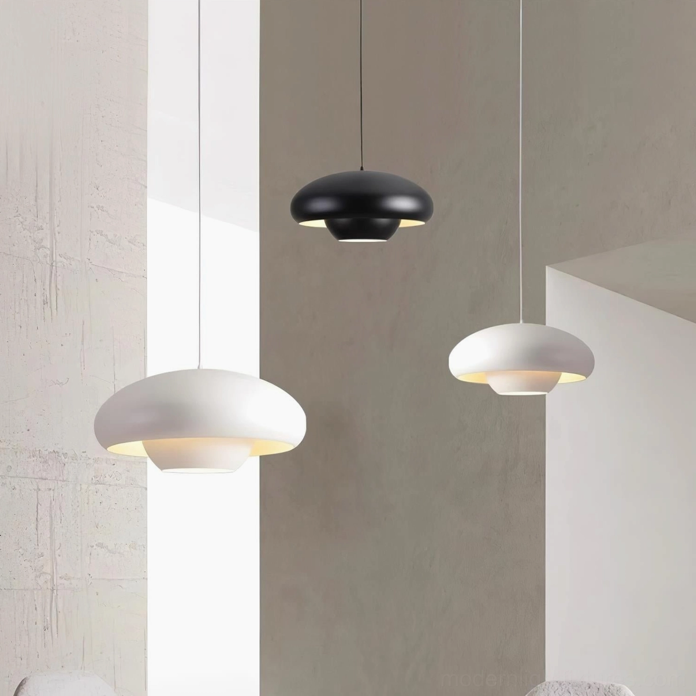 Vario modern pendant lights in black and white, suspended in contemporary wabi-sabi interior space with warm ambient lighting
