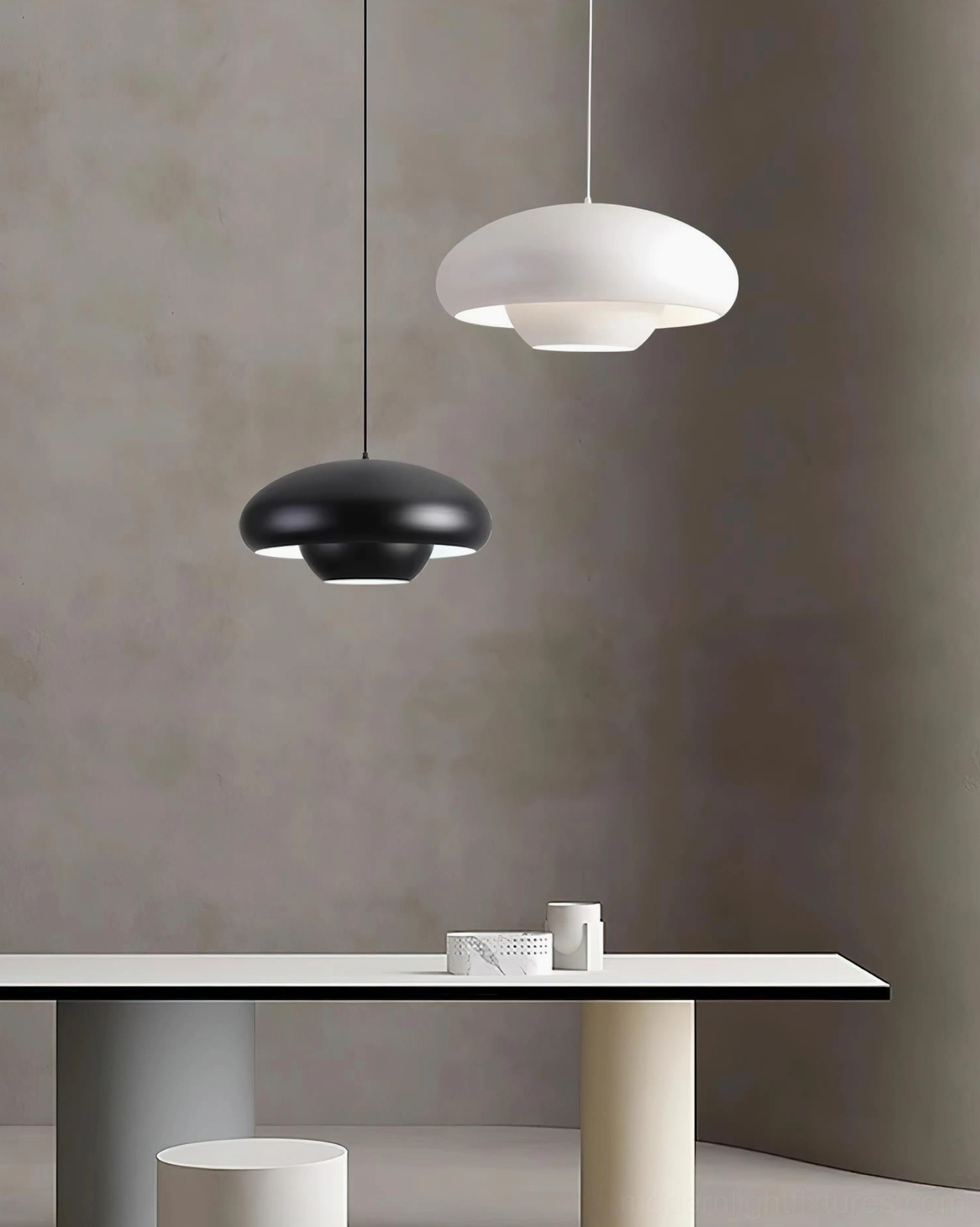 Black and white dome pendant lamps in minimalist dining room with concrete wall, contemporary neutral interior design