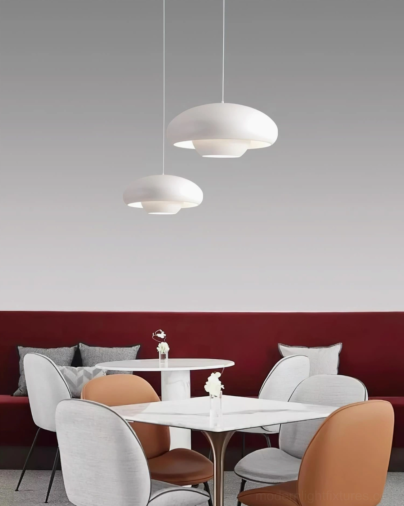 White dome pendant light in cozy cafe setting with red booth seating, creating warm casual minimalist ambiance