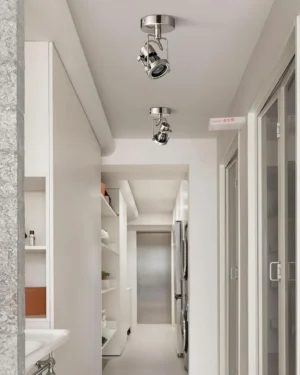 Adjustable ceiling spotlight installation in modern residential hallway with rotatable nickel metal lamp heads