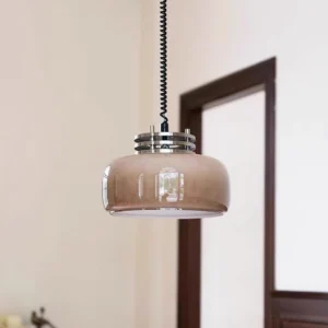 Vela vintage pendant lamp suspended in traditional hallway with dark wood trim, overhead three-quarter perspective