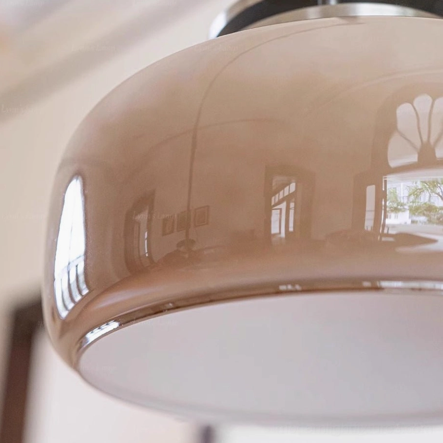 Vela pendant light showing warm light diffusion through translucent glass drum, illumination demonstration