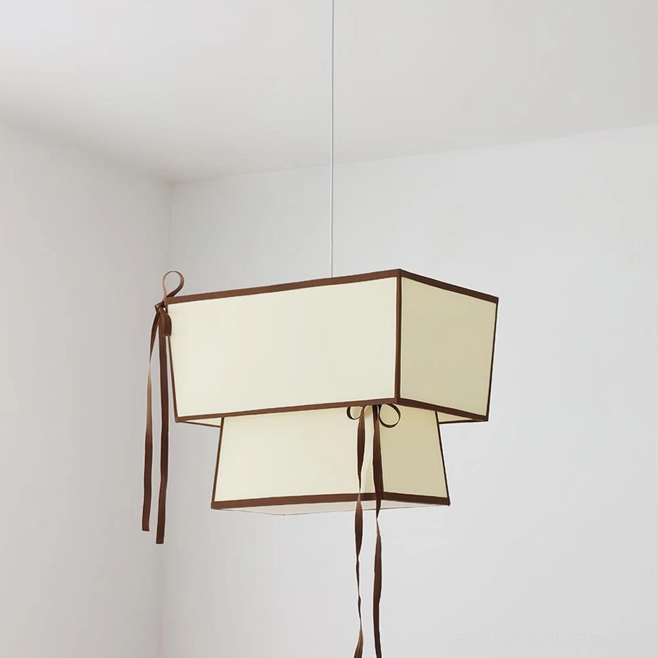 Beige Velina fabric pendant light with dark brown trim and delicate ribbon cascade details