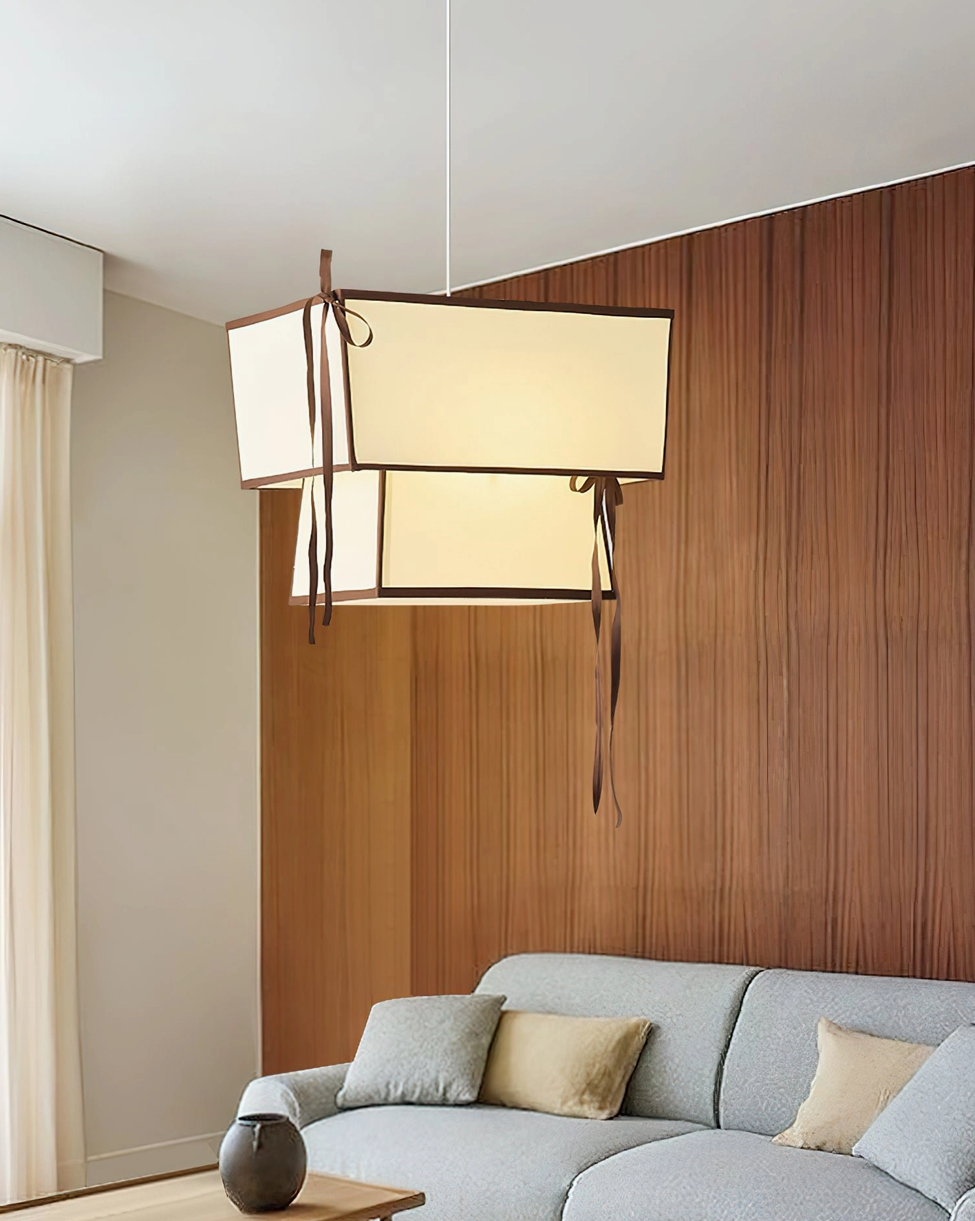 Velina modern pendant light in contemporary living room with illuminated cream fabric shade