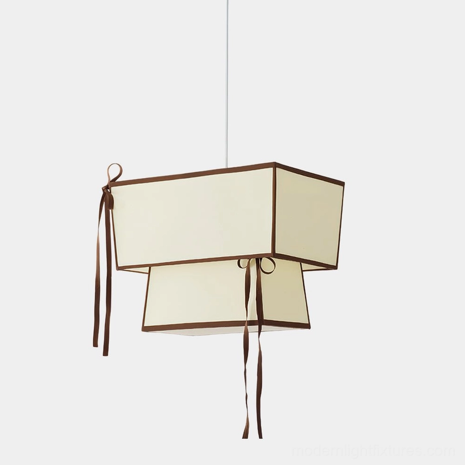 Velina modern two-tier fabric pendant light with chocolate brown trim and cascading ribbons, front studio view