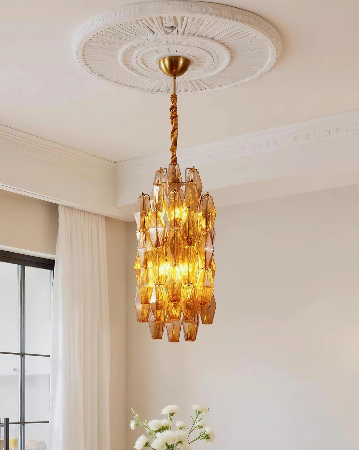 Velthra glass pendant light installed overhead in formal dining room with ornate ceiling medallion