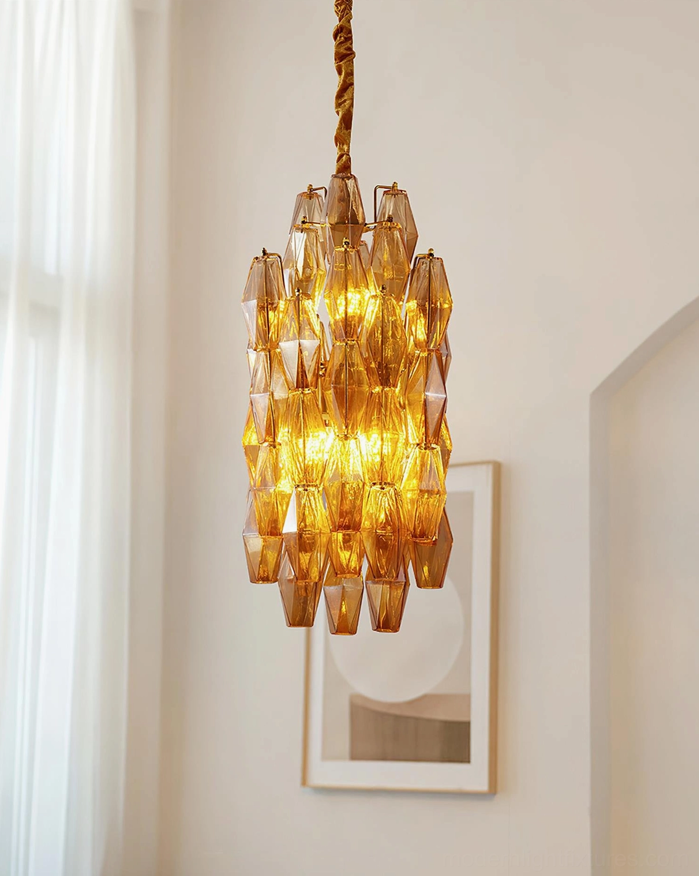 Velthra geometric pendant light with braided golden chain in hallway with warm accent lighting