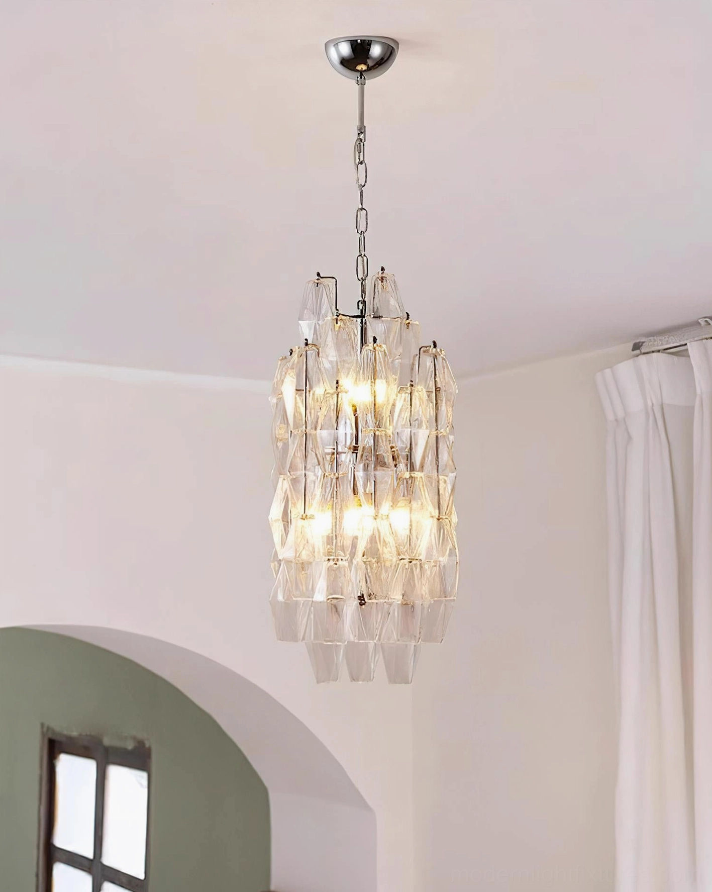 Velthra faceted glass pendant light with ambient warm illumination in luxury home interior