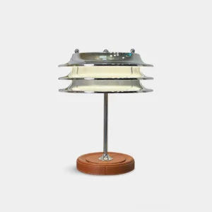 Veltrix modern tiered chrome table lamp with brown leather base, front studio view
