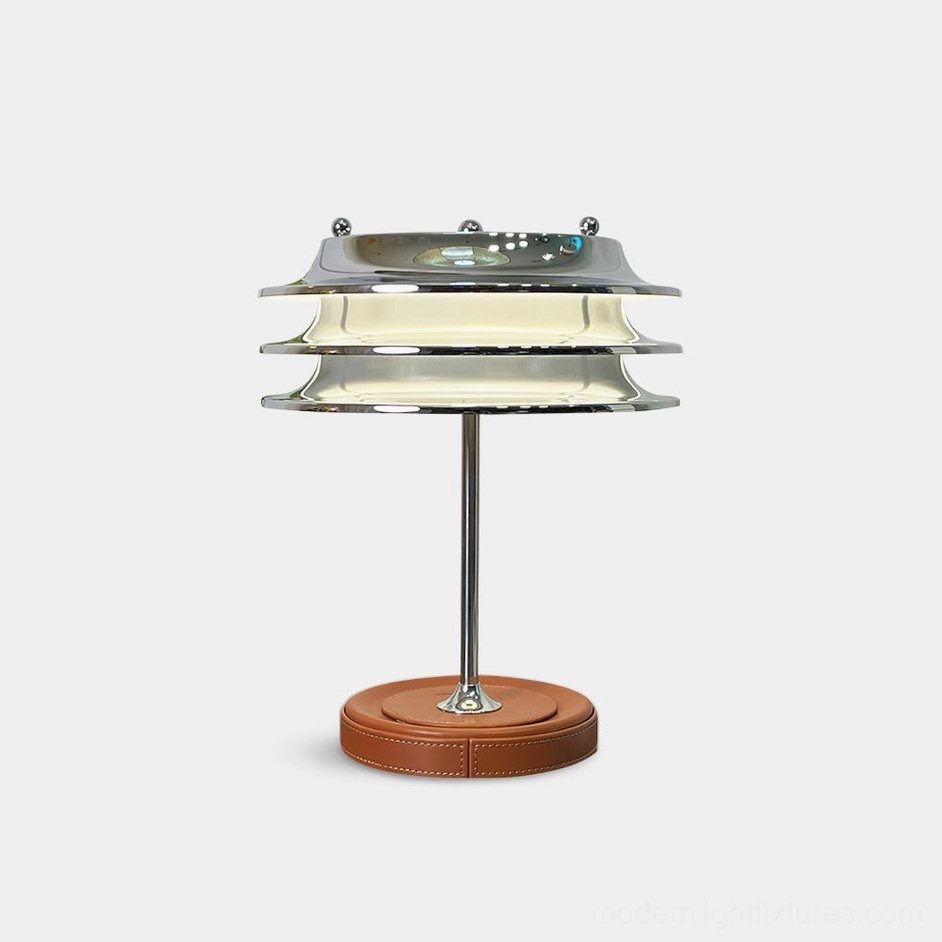 Veltrix modern tiered chrome table lamp with brown leather base, front studio view