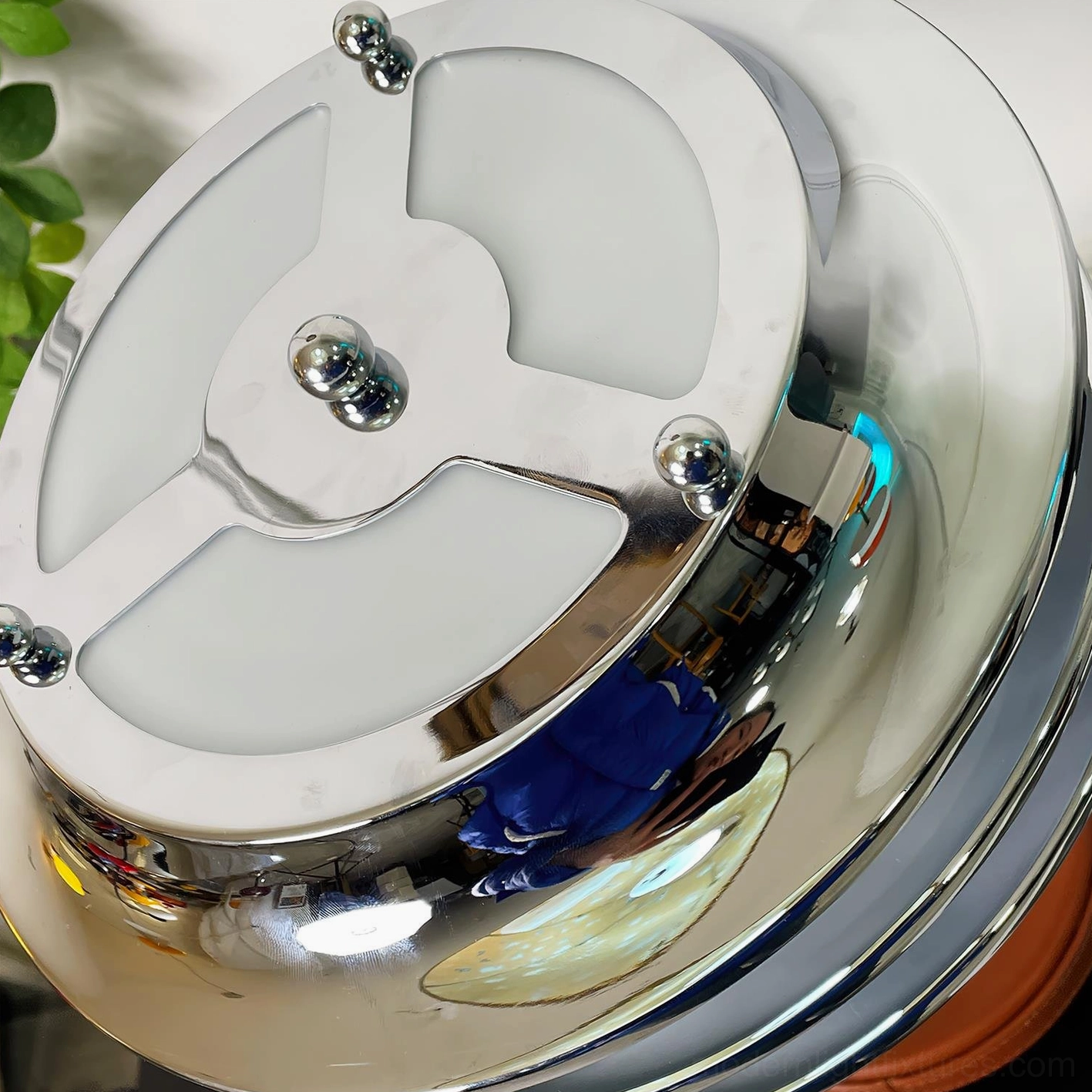 Close-up detail of polished chrome tiered shade and frosted glass diffusers