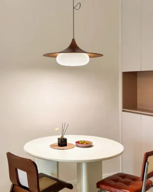 Mid-century modern swing arm pendant lamp installed in contemporary dining nook with warm ambient lighting
