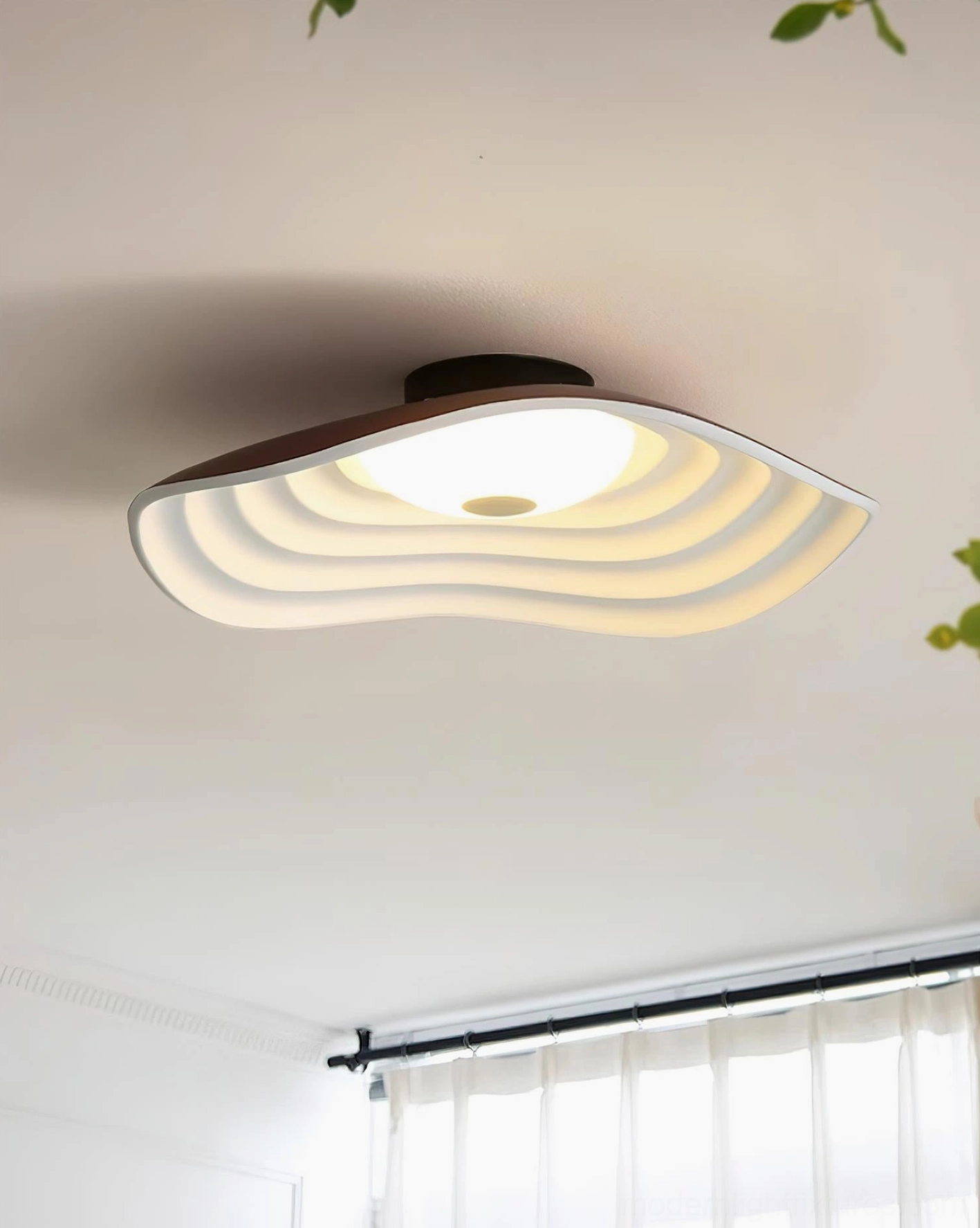 Veneria wavy ceiling lamp mounted on white ceiling in residential living space with sheer window curtains and wood-toned edging
