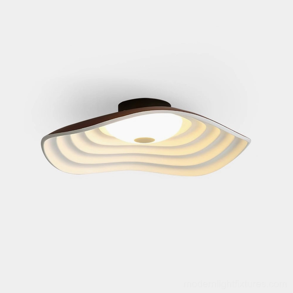 Veneria wavy LED flush mount ceiling light with brown trim and layered matte diffuser in overhead studio view