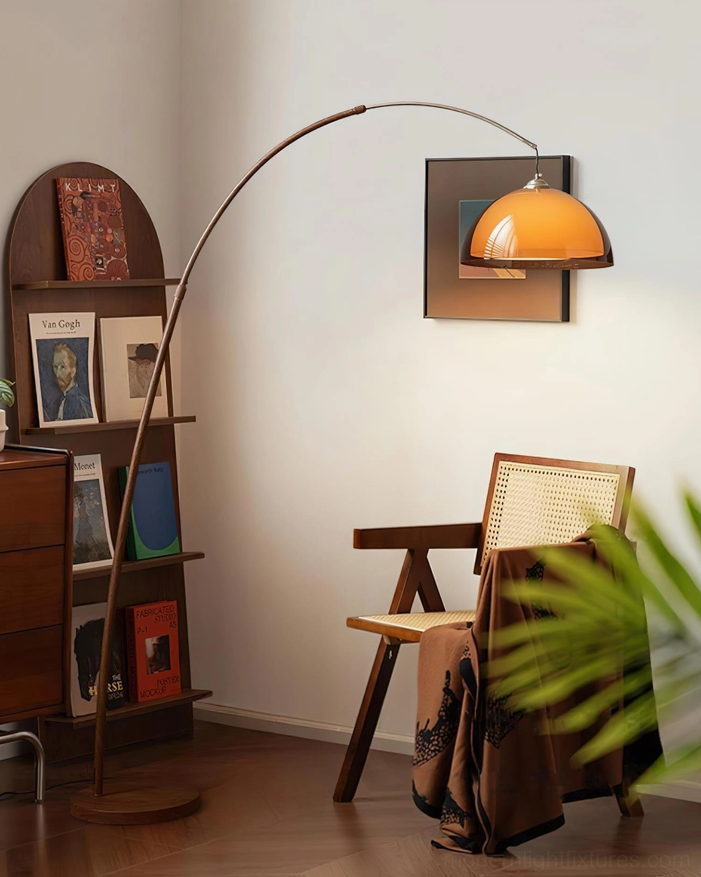 Ventoro arc floor lamp positioned beside woven chair in vintage study, dark brown pole with warm amber lampshade, cozy reading corner setup