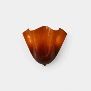 Vera hand-blown amber glass wall sconce with brass base, front studio product view showing sculptural petal-curved shade