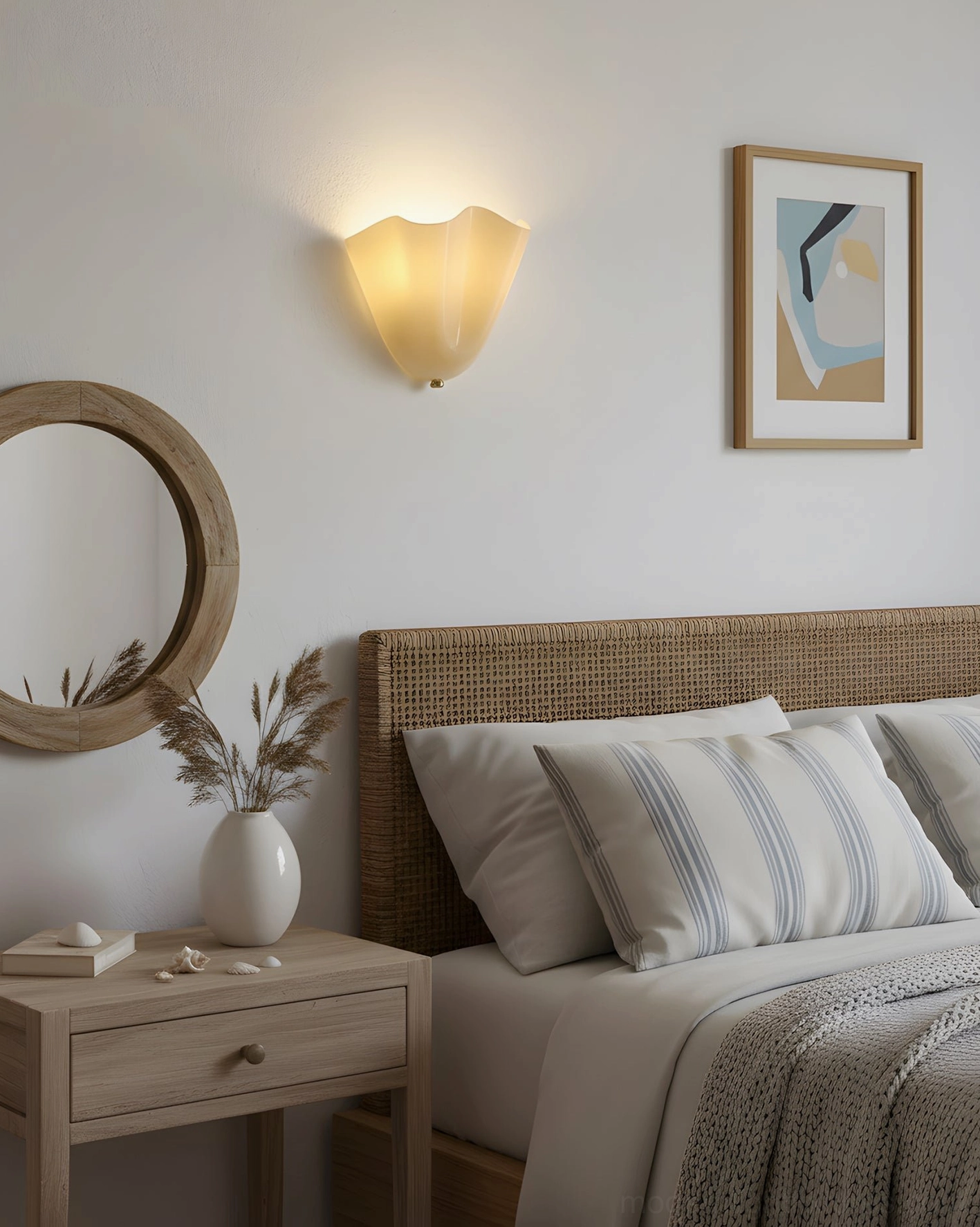 Single Vera cream beige glass wall sconce creating warm ambient light in casual modern coastal cottage bedroom