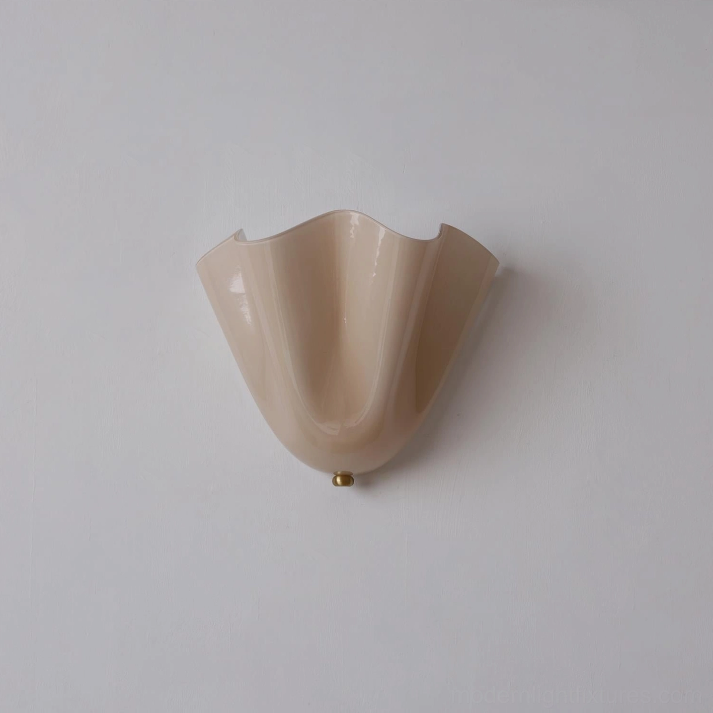 Vera beige glass wall sconce mounted in bright minimalist bathroom with white walls and fixtures