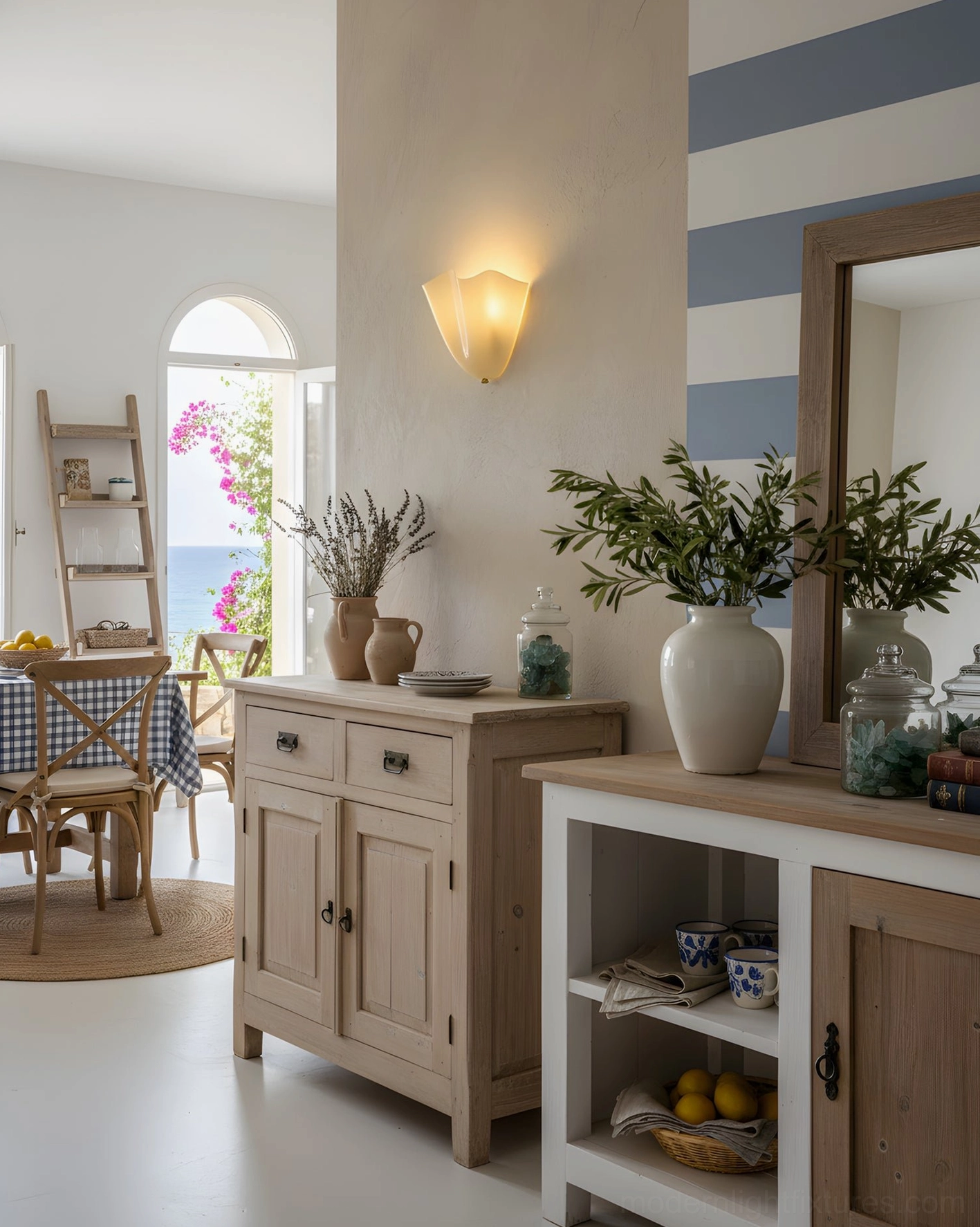 Single Vera beige wall sconce providing warm ambient glow in coastal style living room with natural greenery